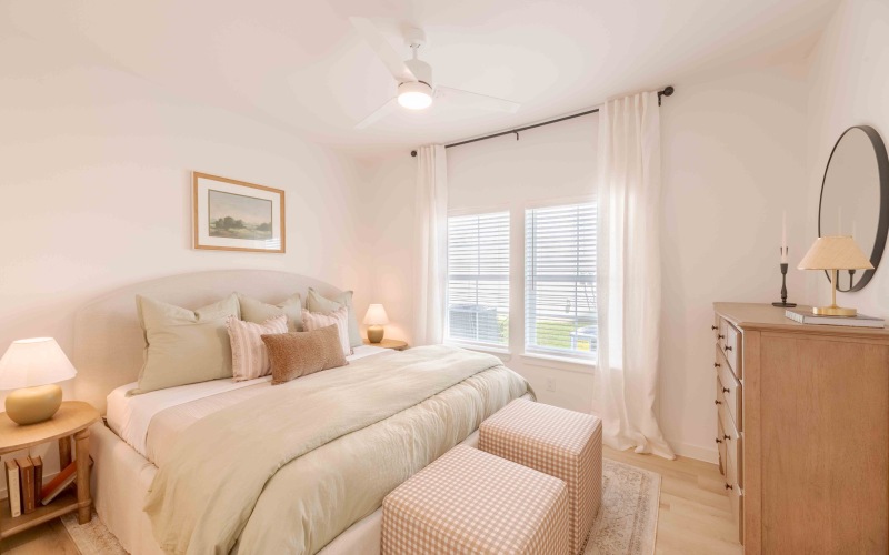 a bedroom with a night stand and dresser